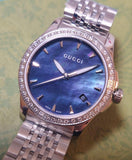  Shop Authentic Gucci G Timeless Diamonds Mother of Pearl Black Dial Silver Mesh Bracelet Watch For Women - YA126507 - Luxxuri